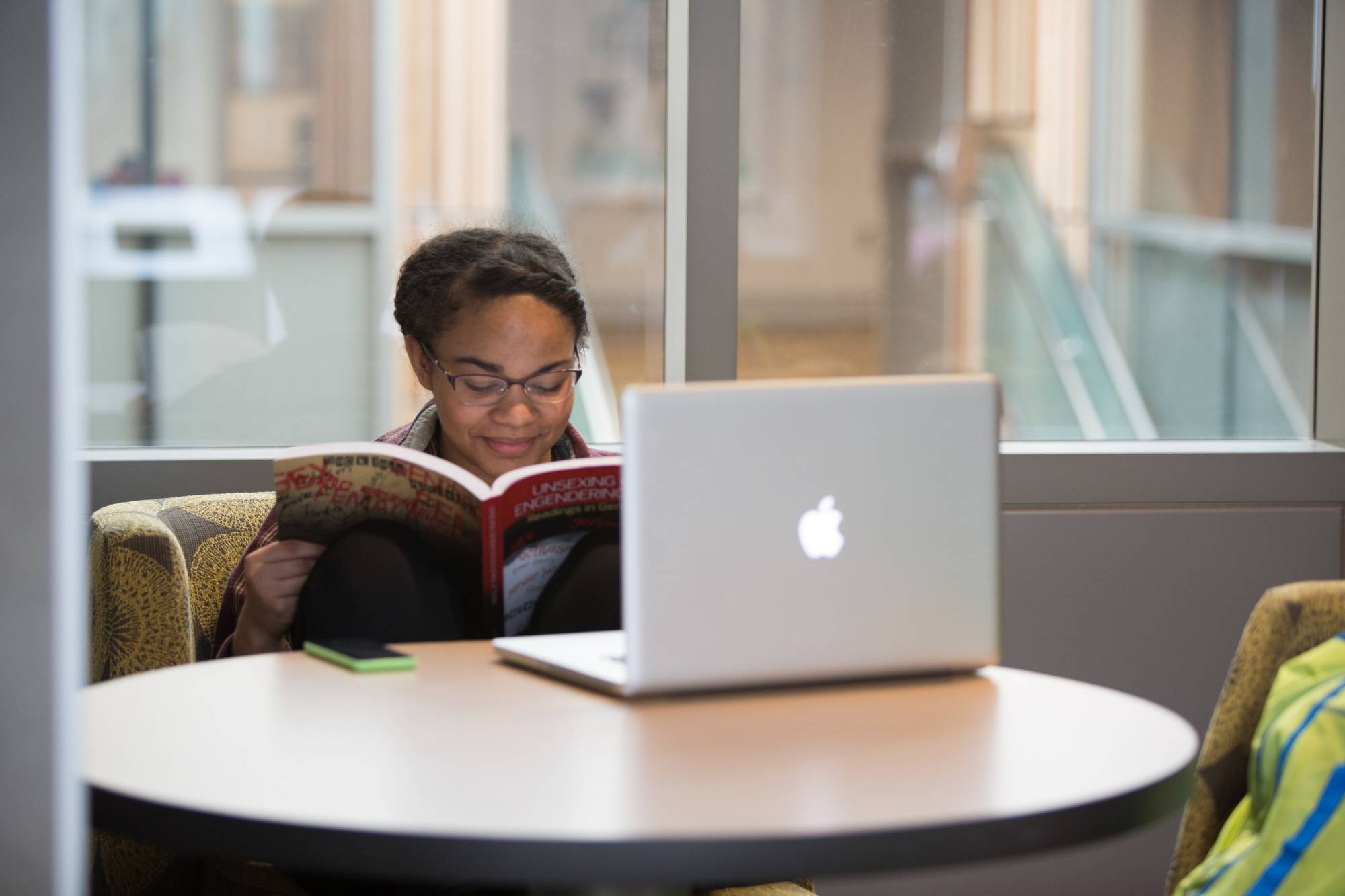 A GVSU student in the library on her computer.